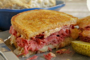 Halved Reuben Sandwich on toasted bread