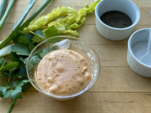 Louisiana Style Remoulade Sauce in bowl with fresh ingredients