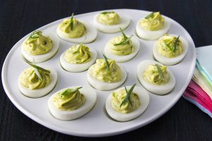 Green Goddess Deviled Eggs arranged on a serving platter