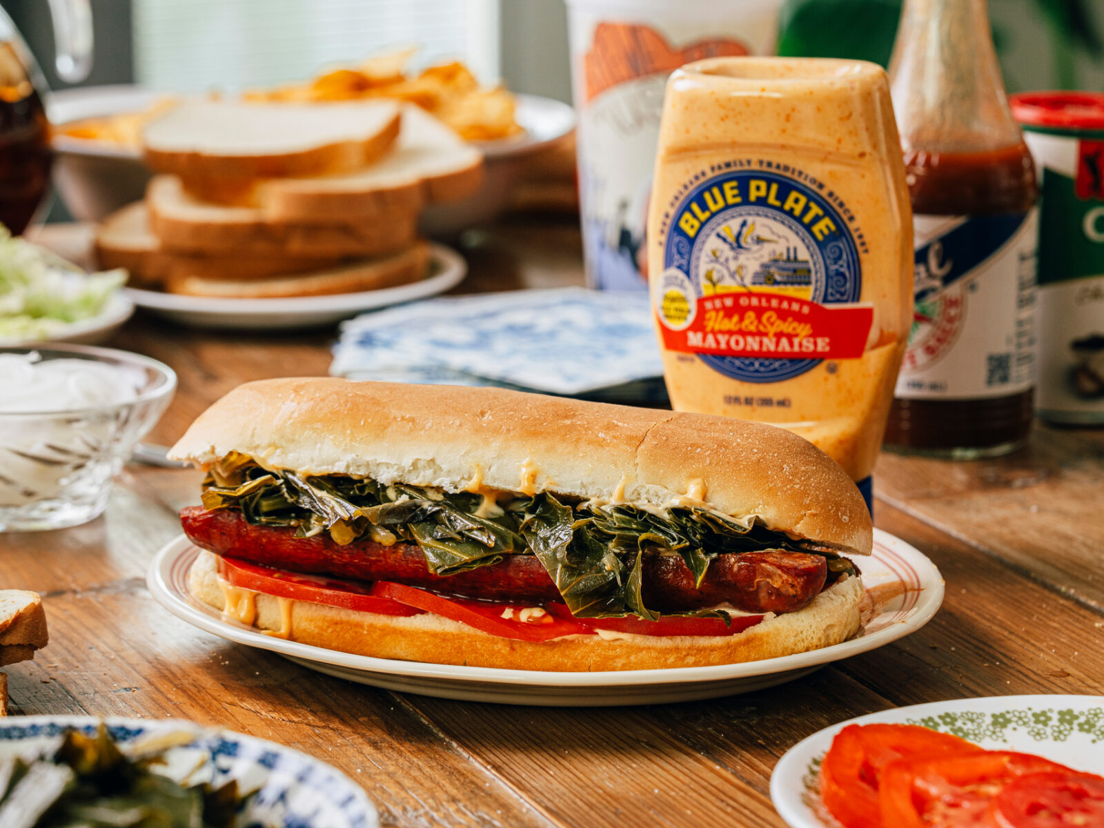 “Cajun BLT” – Hot Sausage, Collards and Tomato Po-Boy