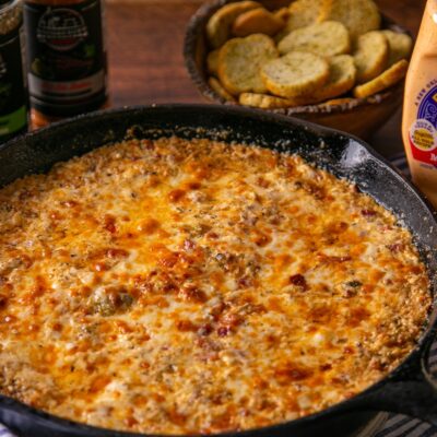 Muffuletta (aka Muffaletta) Dip in iron skillet with croutons for dipping