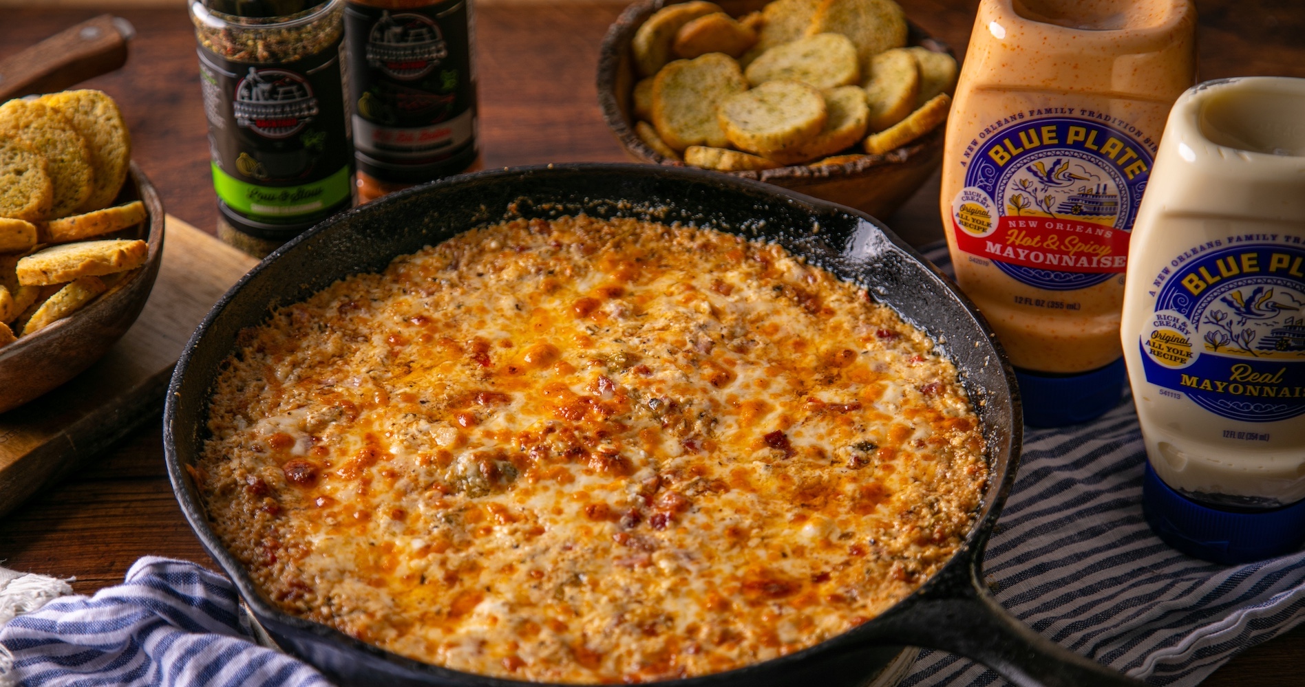 Muffuletta (aka Muffaletta) Dip in iron skillet with croutons for dipping