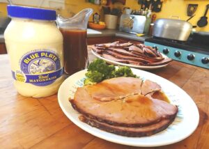 Bon Jambon Baked Ham on a plate with serving platter of ham in background
