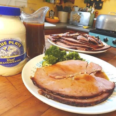 Bon Jambon Baked Ham on a plate with serving platter of ham in background