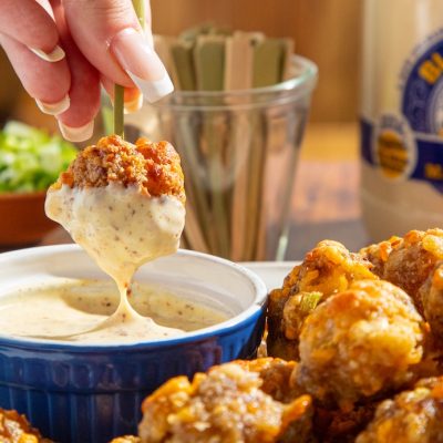 Hot Honey Creole Mustard Dipping Sauce in dish with Sausage Meaballs
