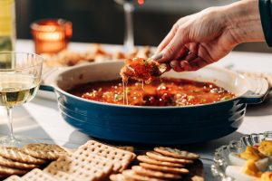 Hot Boudin Dip topped with red pepper jelly
