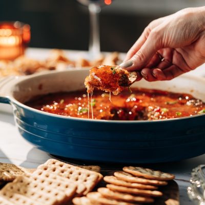 Hot Boudin Dip topped with red pepper jelly